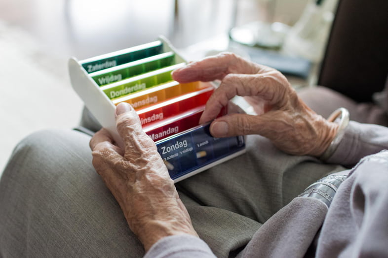 La personne âgée vérifie les médicaments qu'elle doit prendre chaque jour